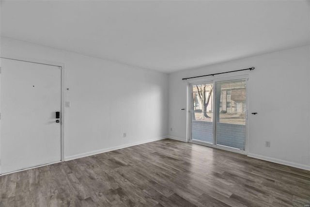 unfurnished room with hardwood / wood-style flooring