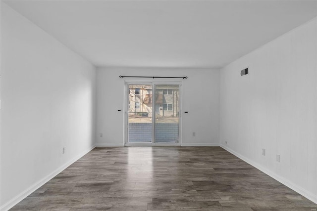 unfurnished room with dark hardwood / wood-style floors