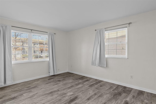 unfurnished room featuring plenty of natural light and light wood-type flooring