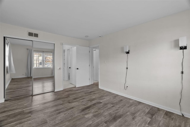 unfurnished room featuring hardwood / wood-style floors