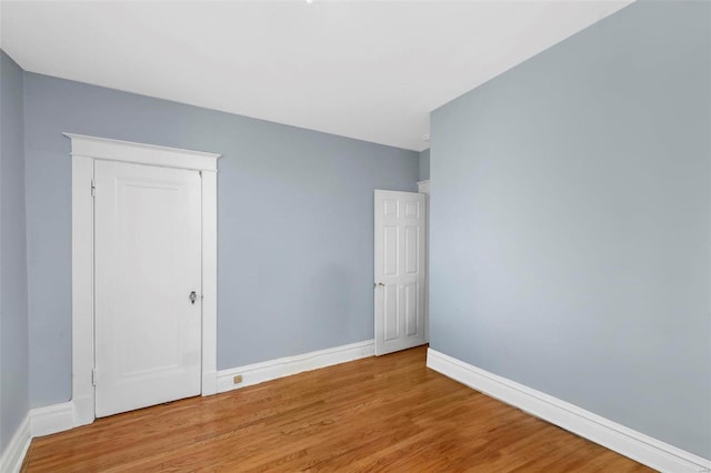 empty room with wood-type flooring