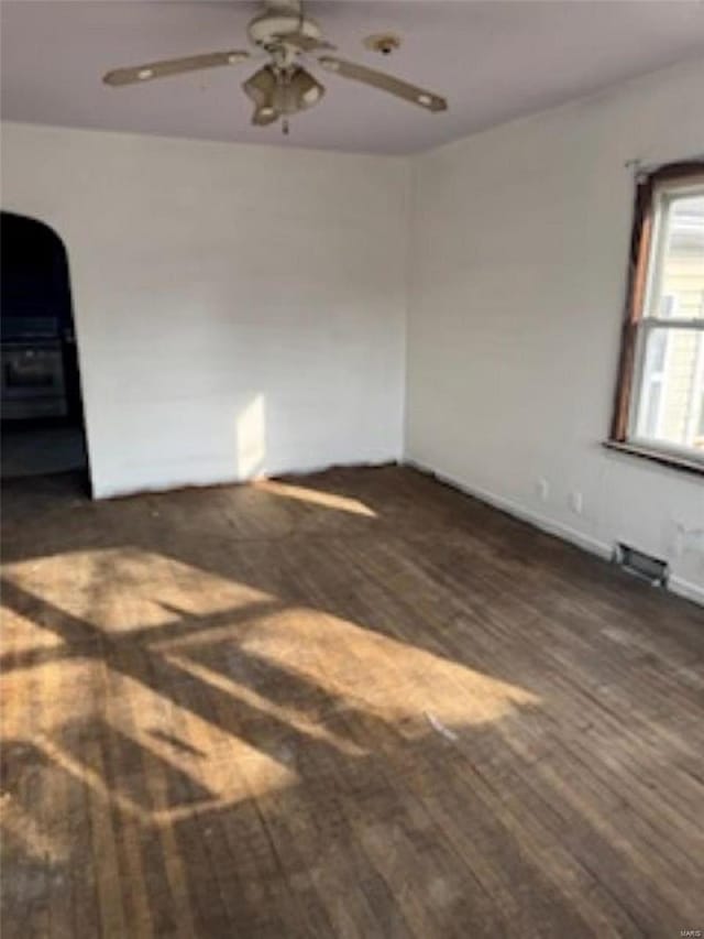 unfurnished room featuring ceiling fan and dark hardwood / wood-style flooring