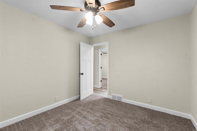 spare room featuring ceiling fan and carpet floors