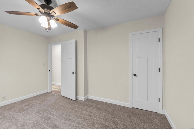 unfurnished bedroom featuring ceiling fan and light colored carpet