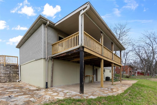 rear view of house featuring a patio area, a wooden deck, and central AC unit