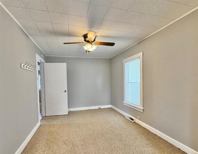 unfurnished room featuring ceiling fan and carpet flooring