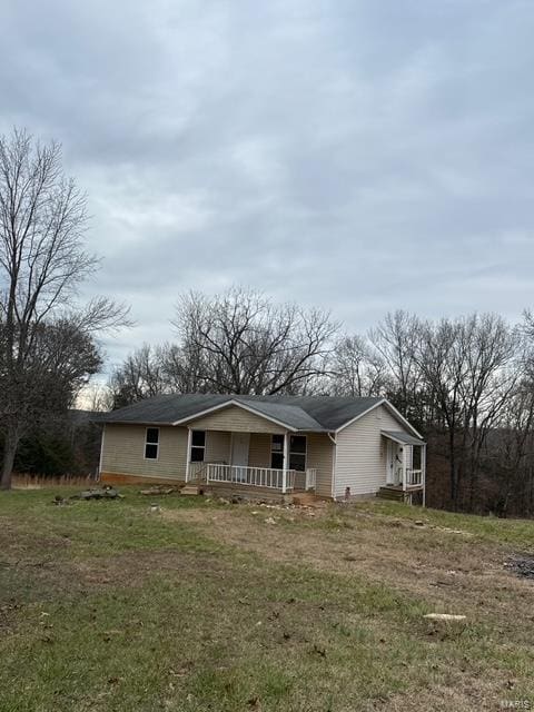 exterior space with a porch and a yard