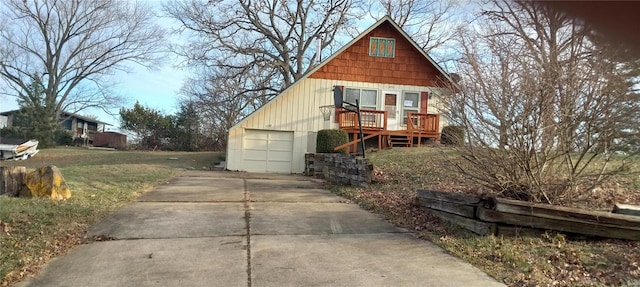 view of front of property featuring a garage, an outdoor structure, and a wooden deck