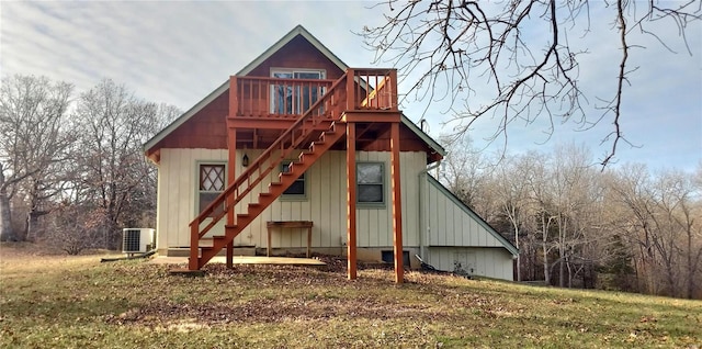 rear view of house featuring a yard, cooling unit, and a deck