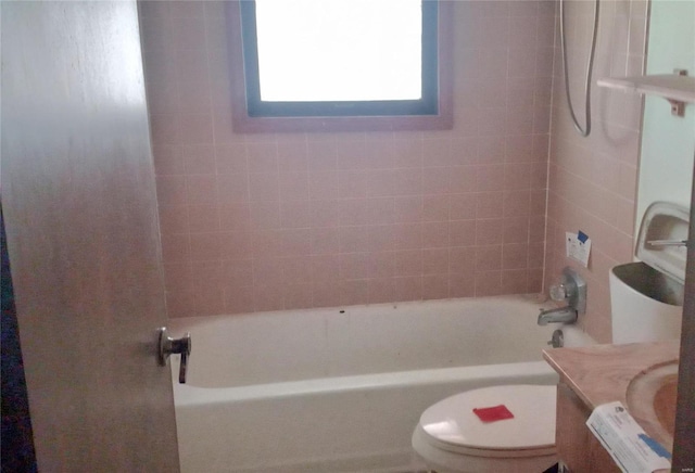 full bathroom with vanity, toilet, and tiled shower / bath