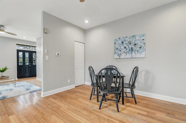 dining area with ceiling fan and light hardwood / wood-style flooring