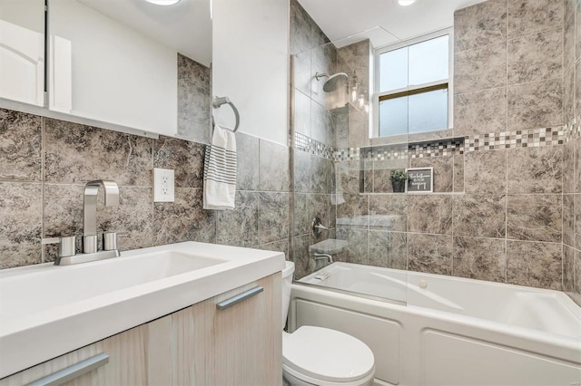 full bathroom with vanity, tiled shower / bath combo, decorative backsplash, toilet, and tile walls