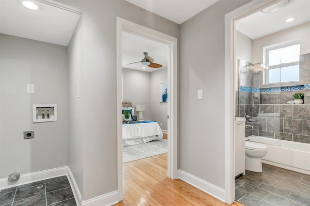 laundry room with electric dryer hookup, ceiling fan, washer hookup, and wood-type flooring