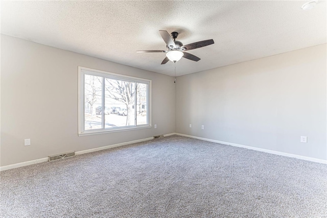 carpeted empty room featuring a textured ceiling and ceiling fan