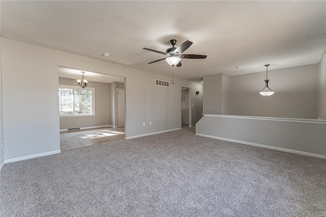 carpeted empty room with ceiling fan and a textured ceiling