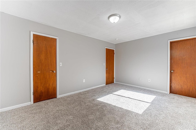 unfurnished bedroom with carpet floors and a textured ceiling