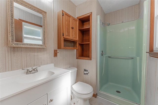 bathroom featuring vanity, toilet, and a shower