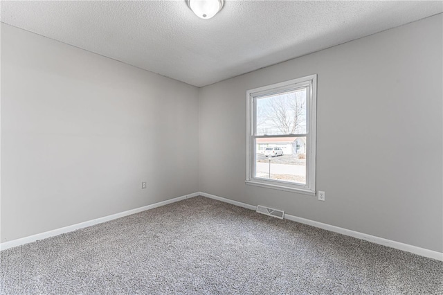 empty room featuring carpet floors and a textured ceiling