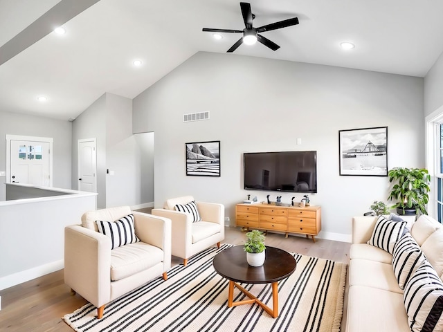 living room with ceiling fan, high vaulted ceiling, and light hardwood / wood-style floors