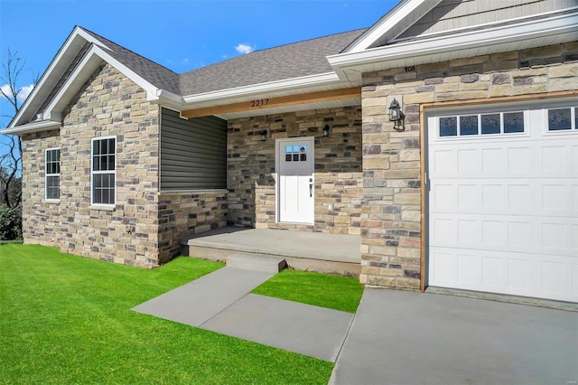 entrance to property with a garage and a yard