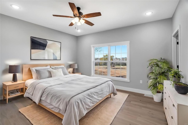 bedroom featuring hardwood / wood-style flooring and ceiling fan