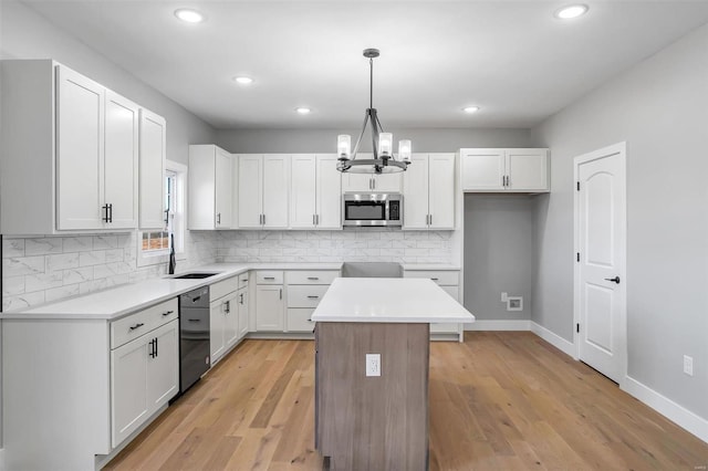 kitchen with hanging light fixtures and white cabinets