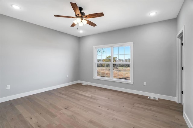 empty room with light hardwood / wood-style floors and ceiling fan