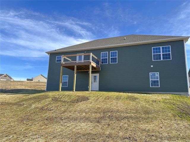 rear view of house featuring a lawn