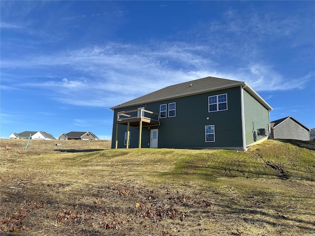 rear view of property featuring a lawn