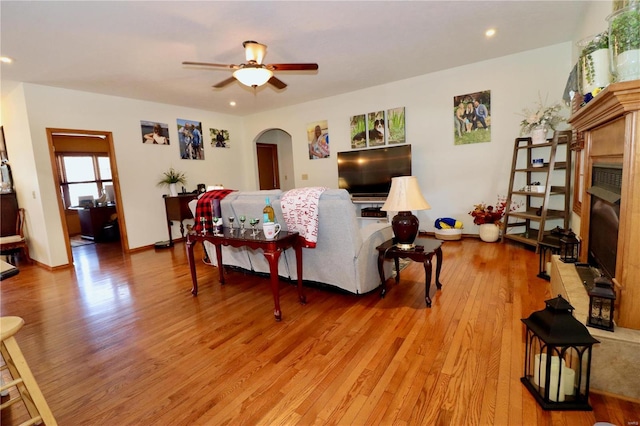 living room featuring ceiling fan and light wood-type flooring