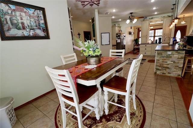 dining area featuring light tile patterned floors and ceiling fan