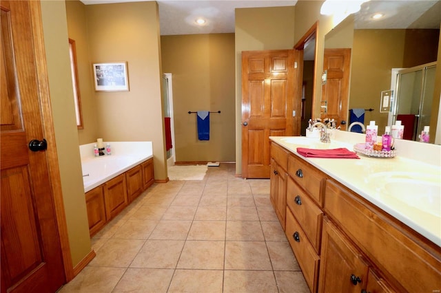 bathroom with tile patterned flooring, vanity, and separate shower and tub