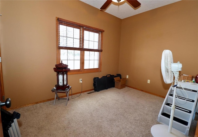 misc room featuring light carpet and ceiling fan