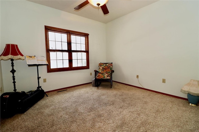 sitting room featuring ceiling fan and carpet flooring