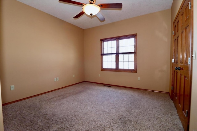 carpeted empty room featuring ceiling fan