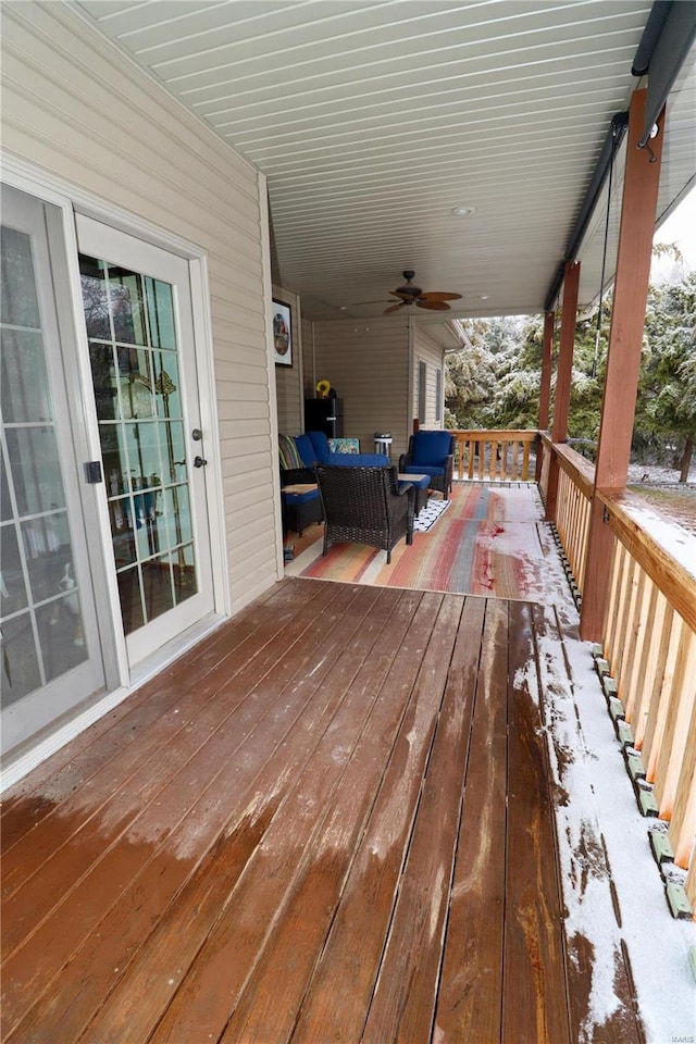 wooden deck featuring an outdoor living space and ceiling fan