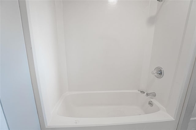 bathroom with bathing tub / shower combination