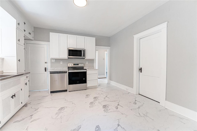 kitchen with stainless steel appliances and white cabinets