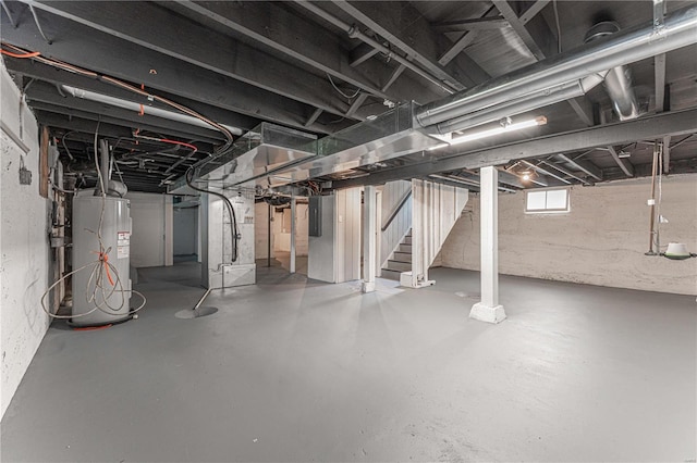 basement with electric panel and electric water heater