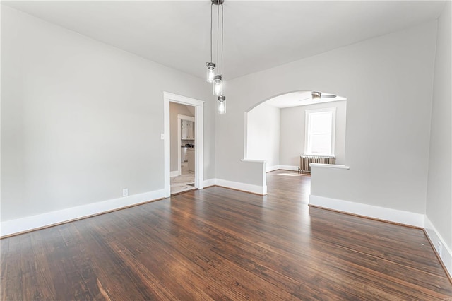 interior space with dark wood-type flooring and radiator