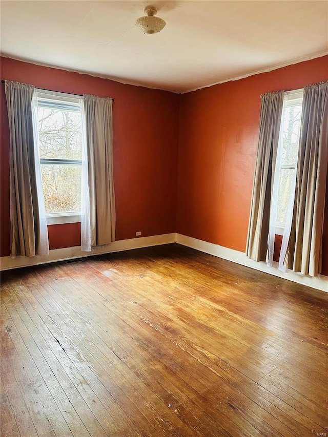 unfurnished room featuring hardwood / wood-style floors