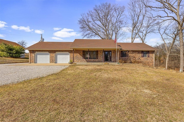 ranch-style house featuring a garage and a front lawn