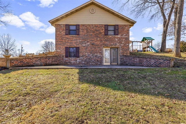 back of house with a yard, a patio area, and a playground