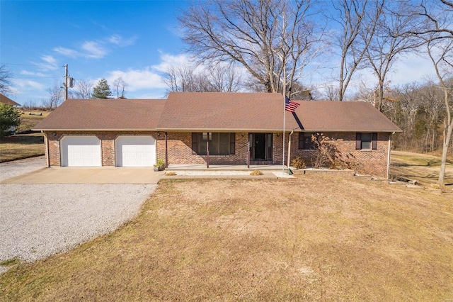 single story home featuring a garage and covered porch