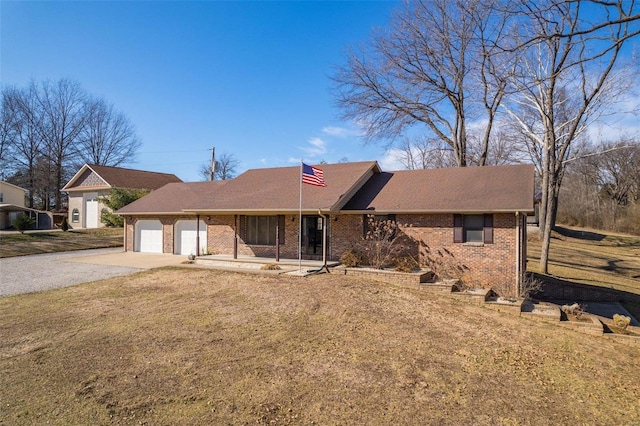 ranch-style home featuring a garage and a front lawn