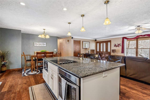 kitchen featuring hanging light fixtures, white cabinetry, dark stone countertops, and black electric stovetop