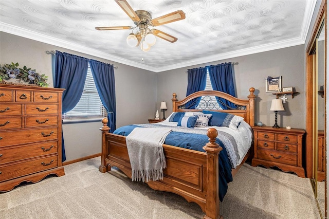 carpeted bedroom with crown molding, a closet, and ceiling fan