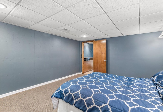 bedroom with a paneled ceiling and carpet