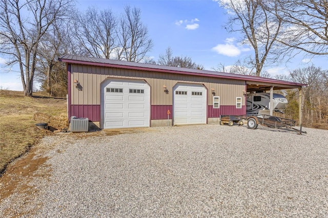 garage featuring a carport and central AC unit