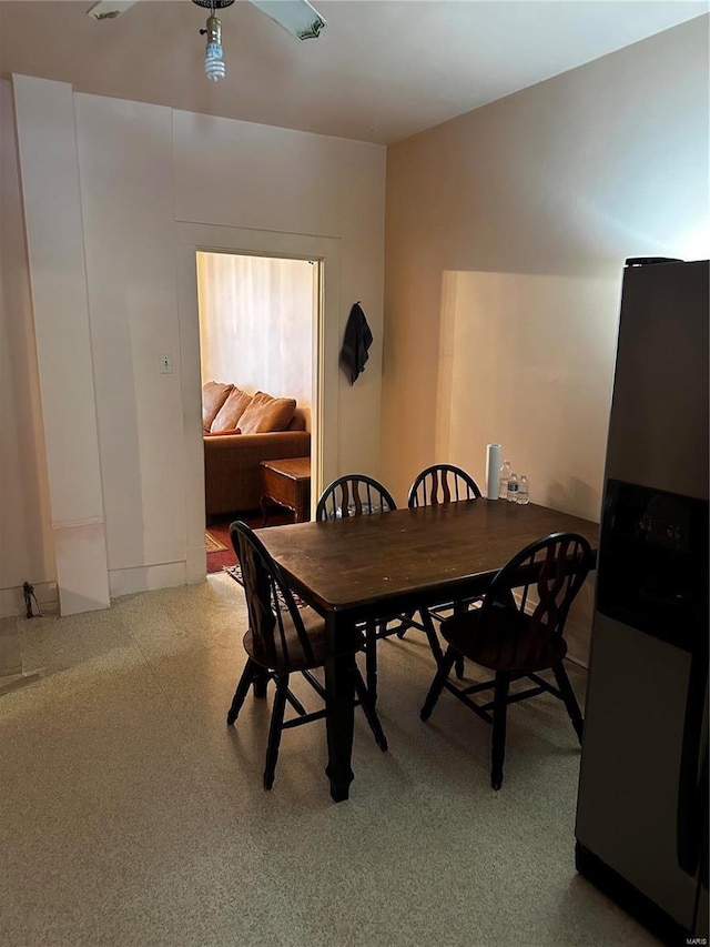 dining space with speckled floor